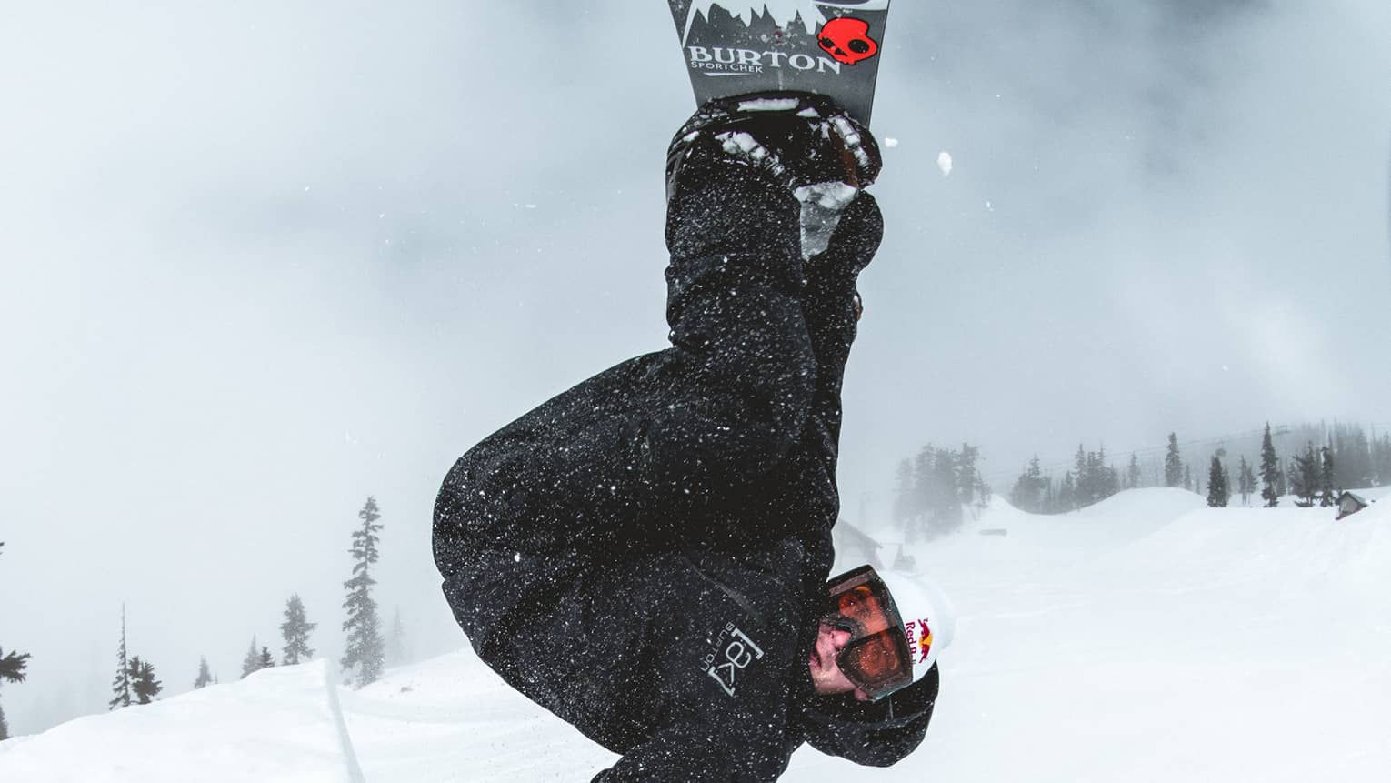 A red bull athlete doing a very difficult flip.